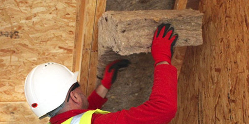 workman installing sheeps wool insulation