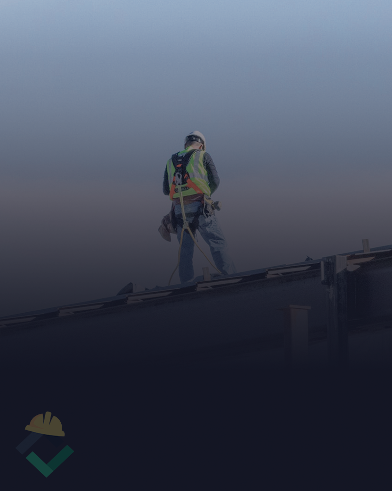 Man stands on roof inspecting his work